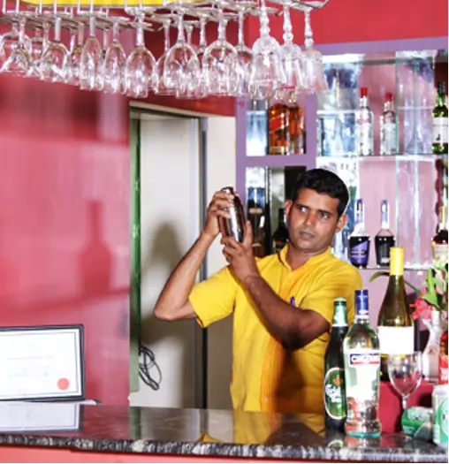 A barman preparing drinks at the open bar at CIC agri resort